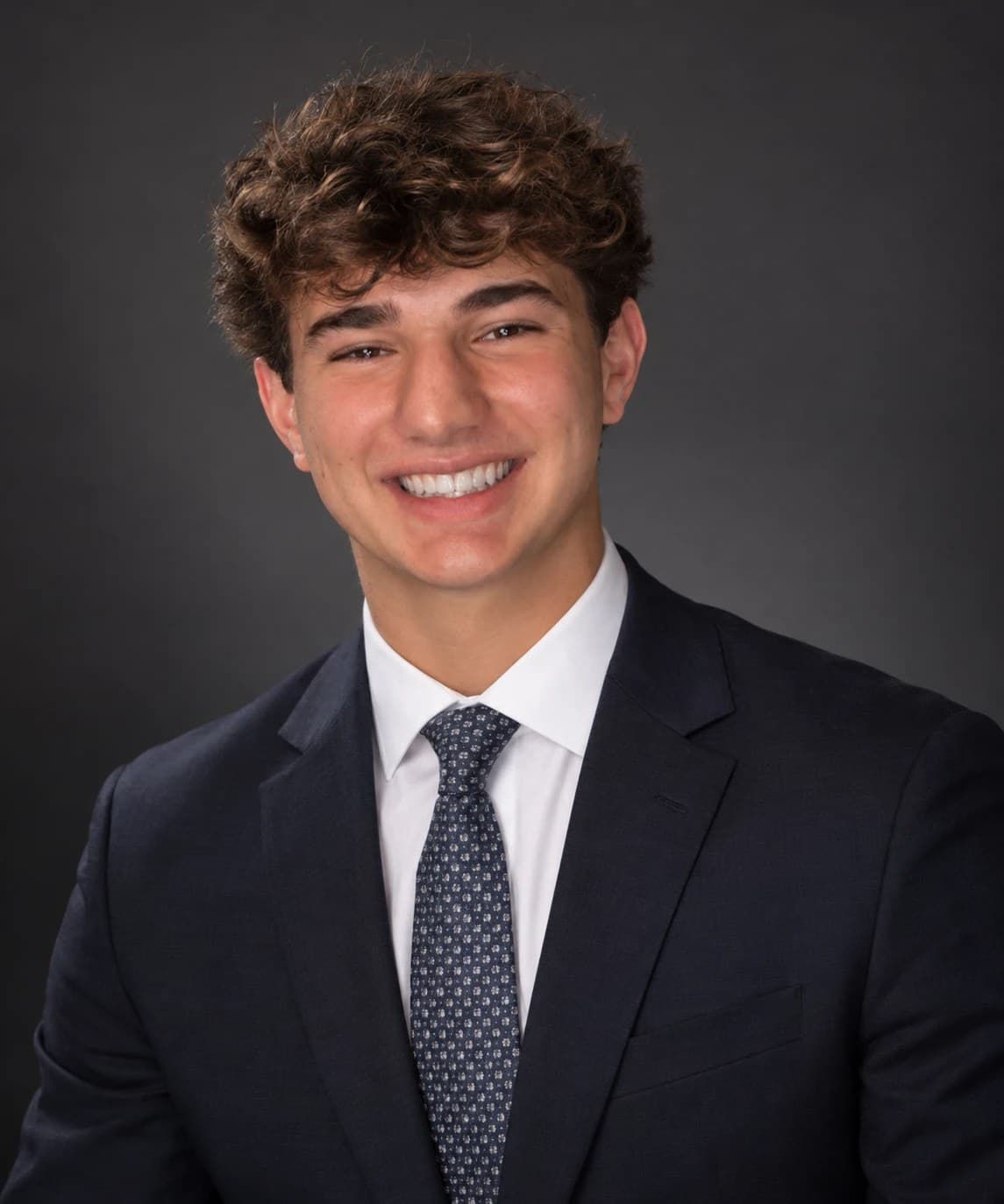 Maxwell Keller, San Diego business operator, in a navy suit and patterned tie